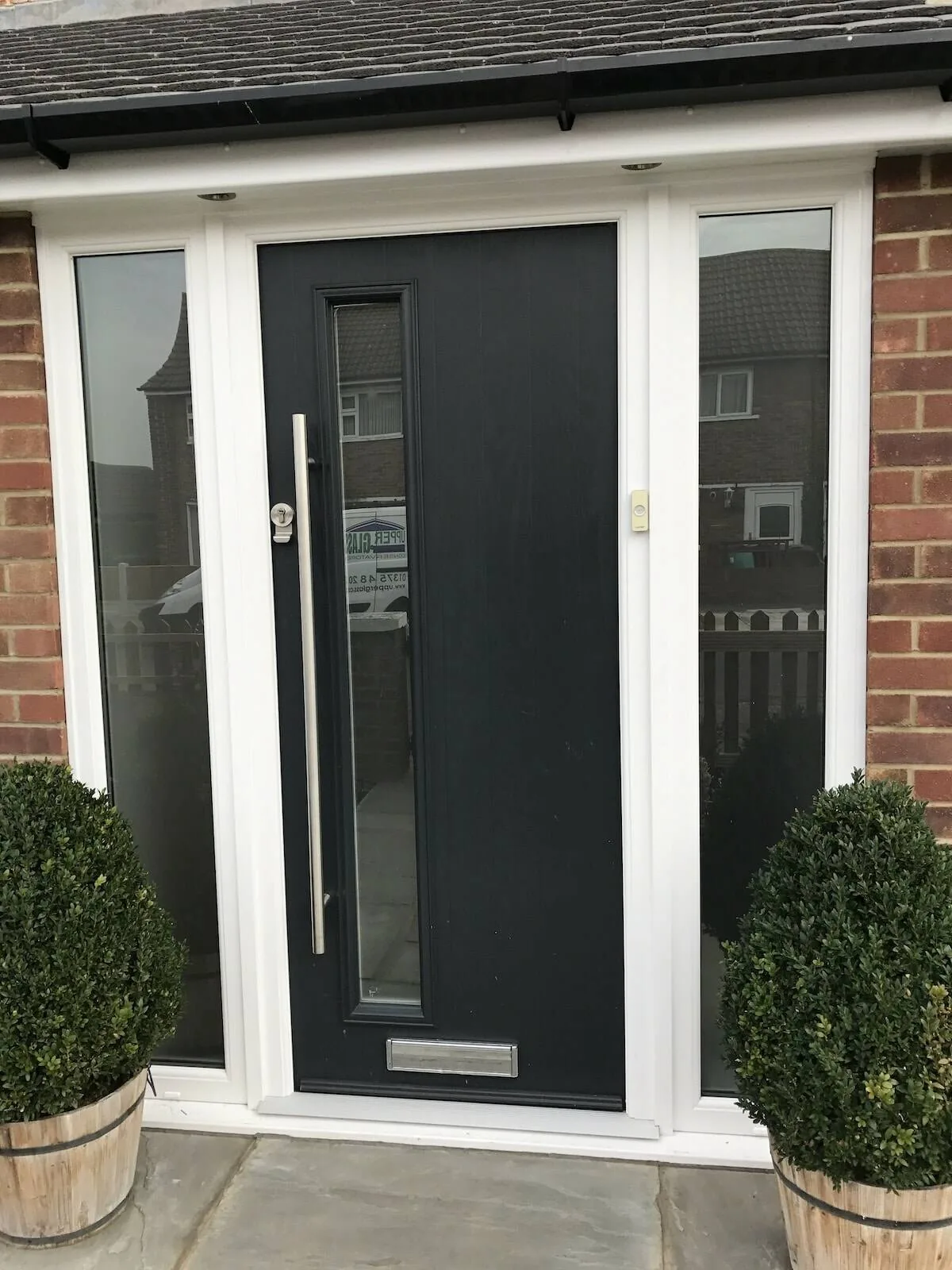 Black composite door with glazed panels, real customer installation