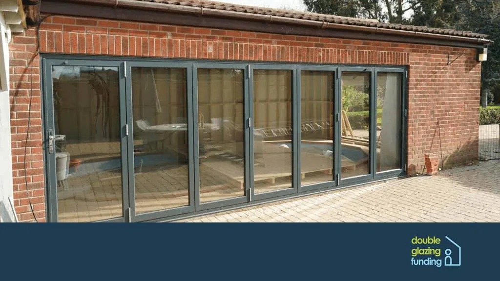 Open bi-fold doors leading from a kitchen to a garden