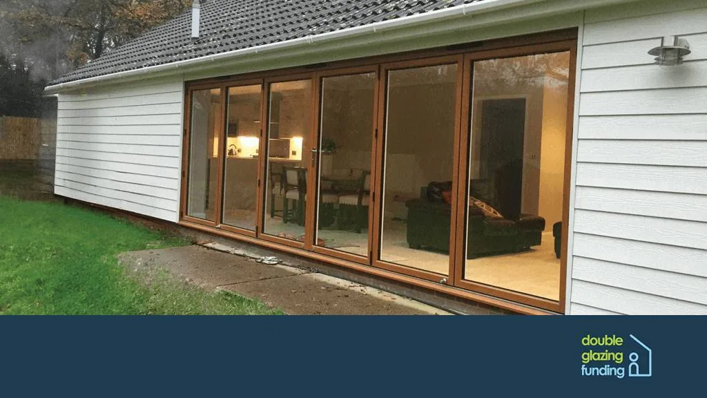 Large golden oak bi-fold doors leading to a garden