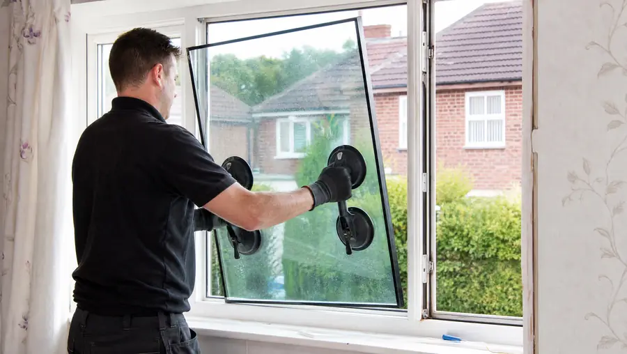 Window technician replacing a misted sealed unit in a uPVC double glazed window