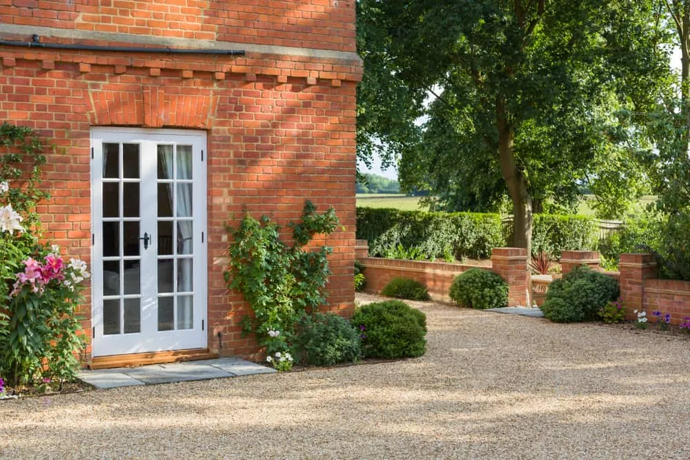 White uPVC French doors opening onto a garden